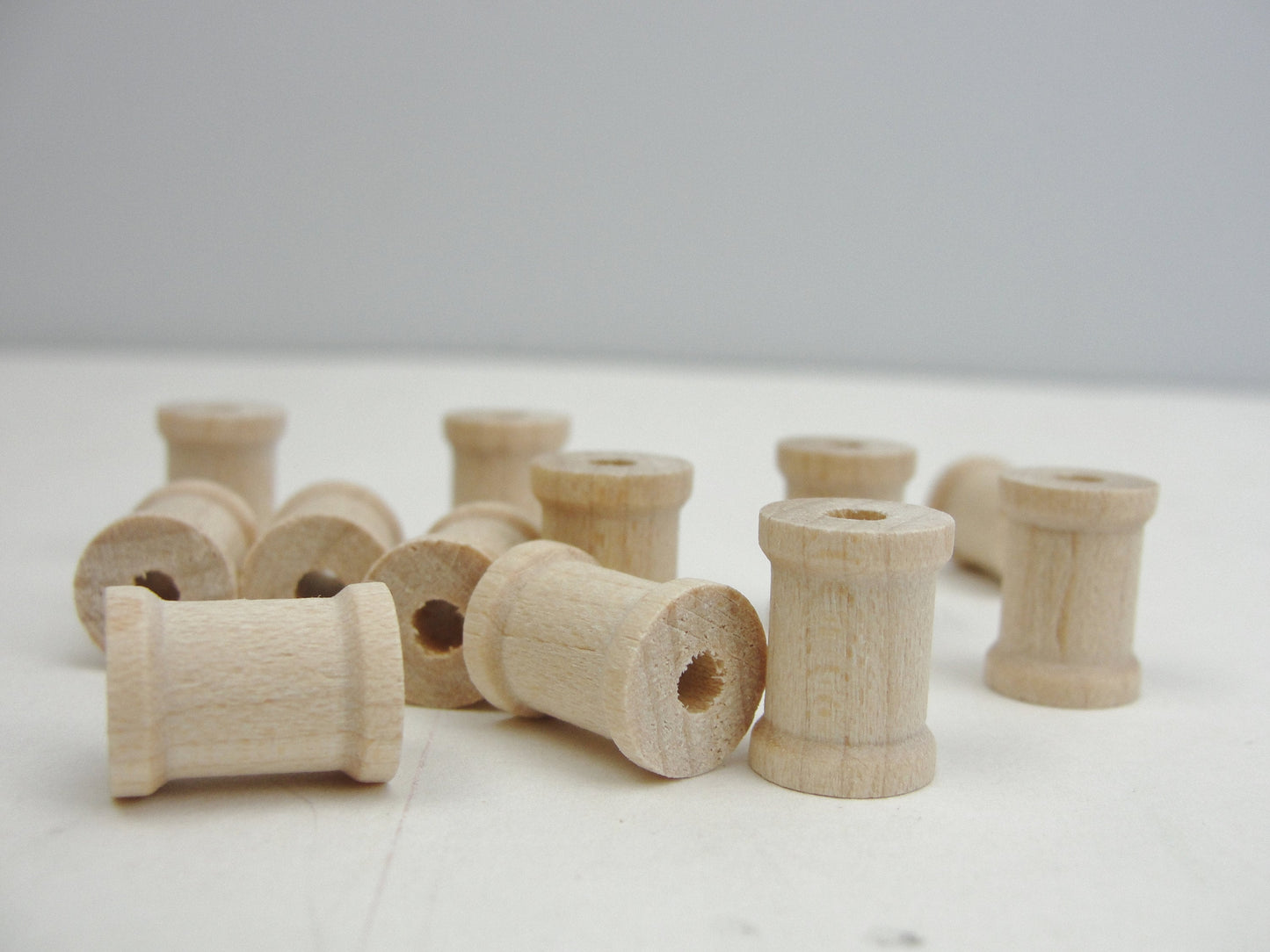 Little wooden spools 1/2" x 3/8" set of 12, wood spools