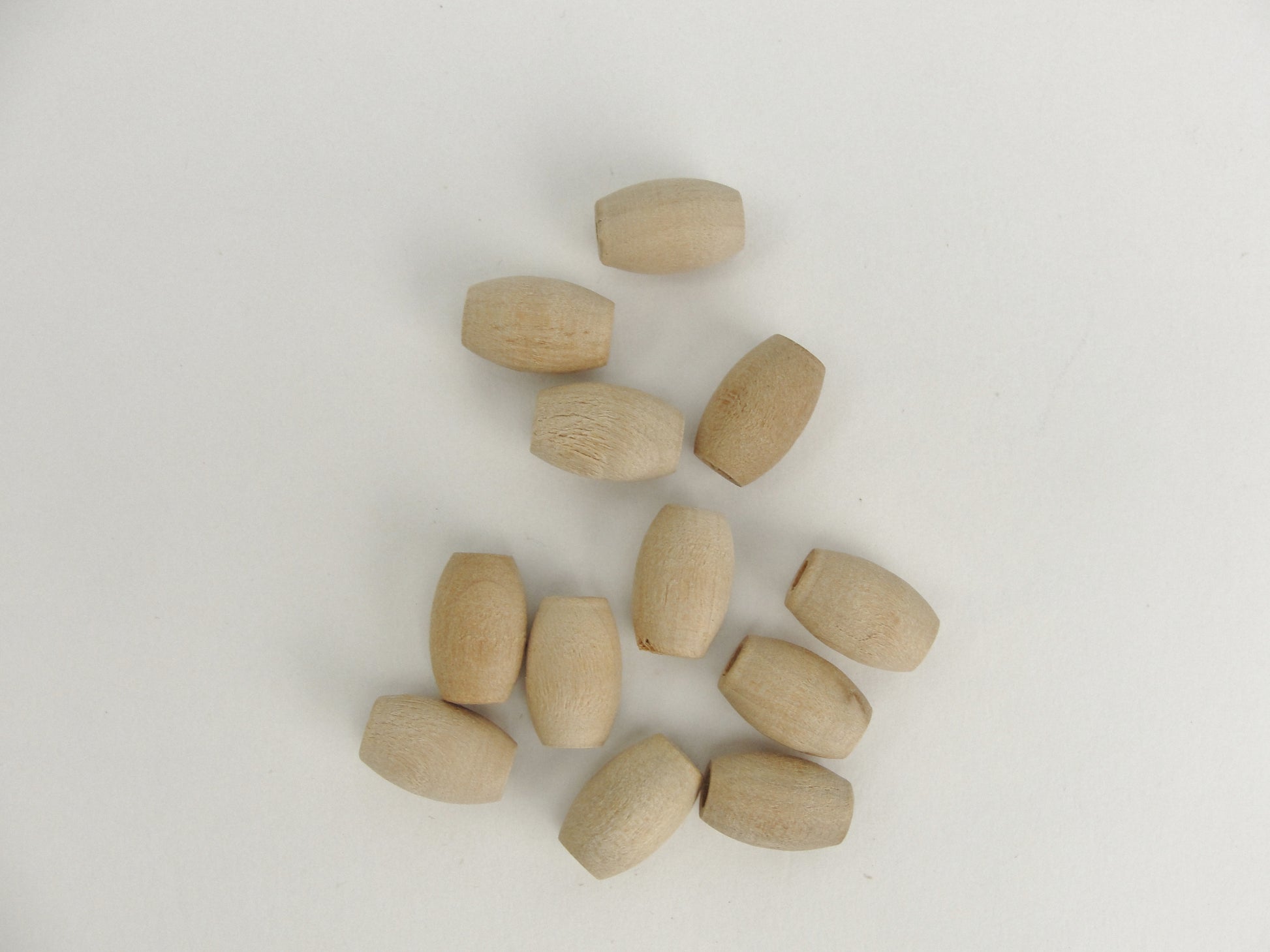 Wooden oval beads 9/16" x 3/8" with a 5/32" hole - Wood parts - Craft Supply House