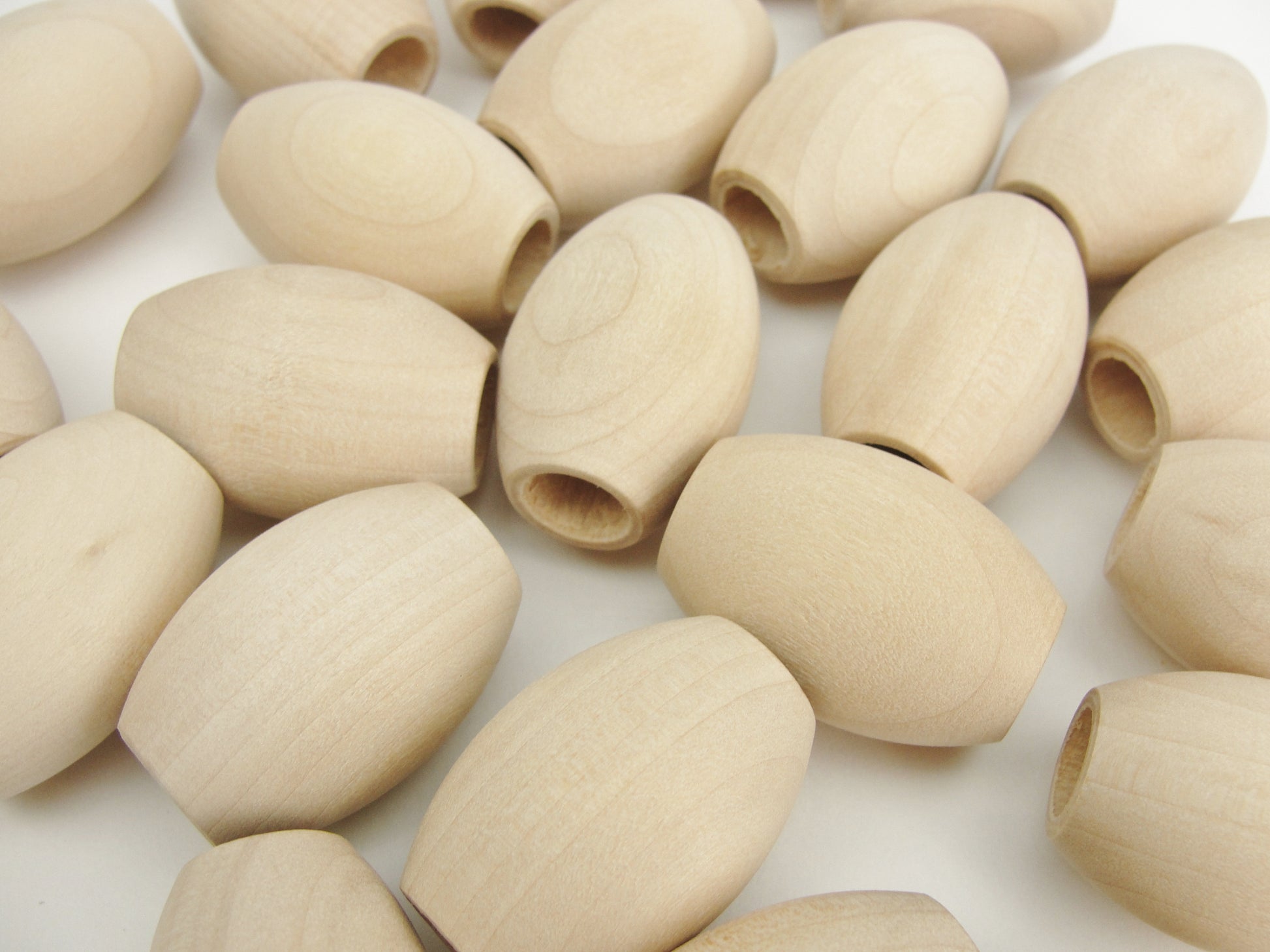 Wooden oval beads 1 1/4" x 7/8" with a 3/8" hole - Wood parts - Craft Supply House