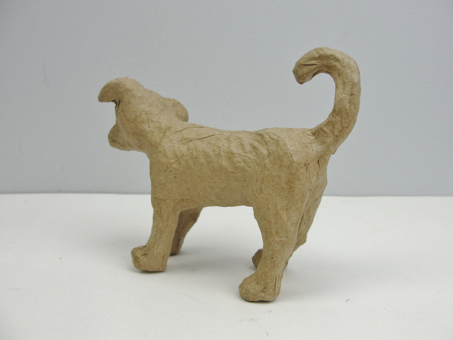 Small Paper mache Dog with curled tail