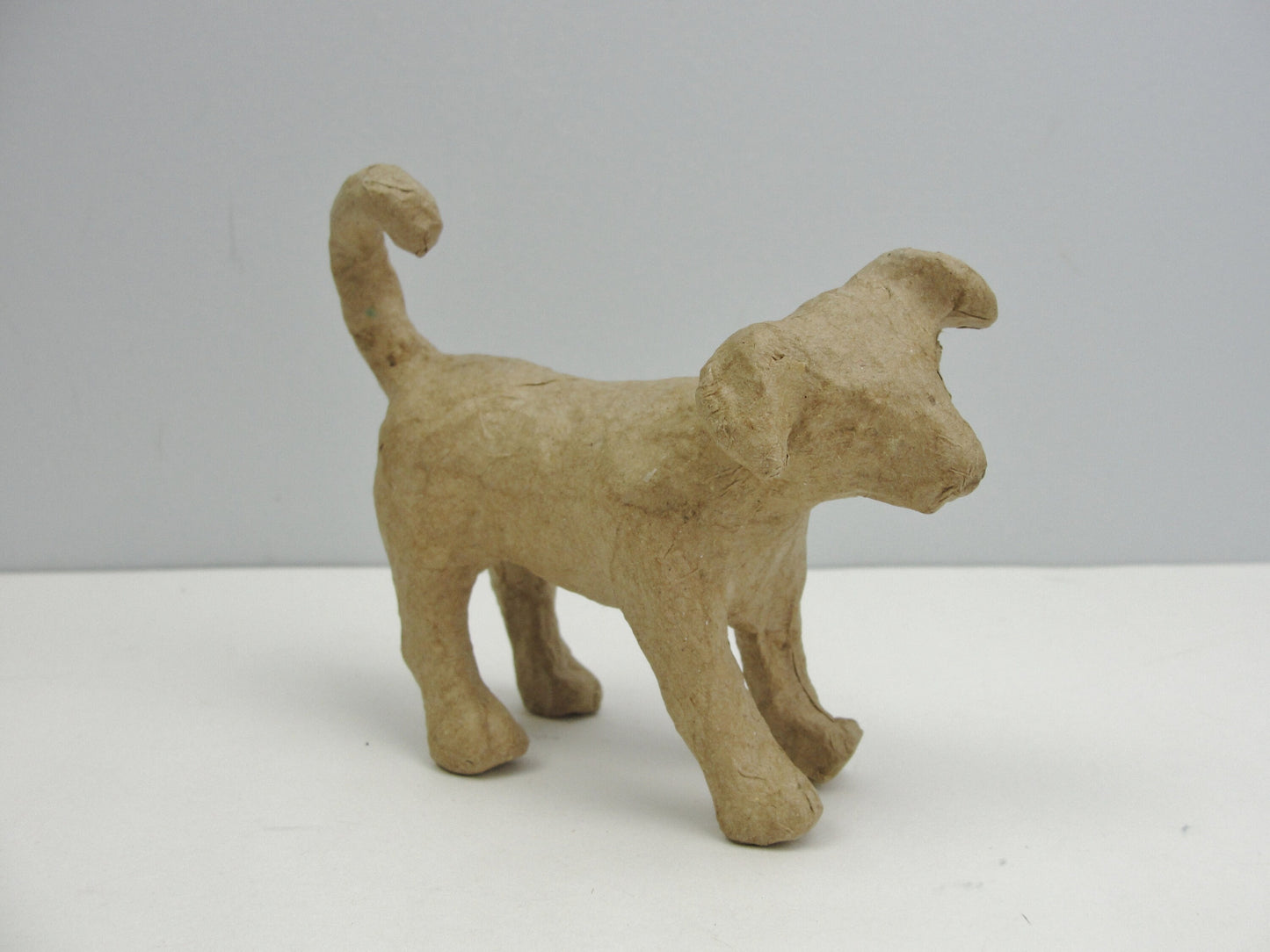 Small Paper mache Dog with curled tail