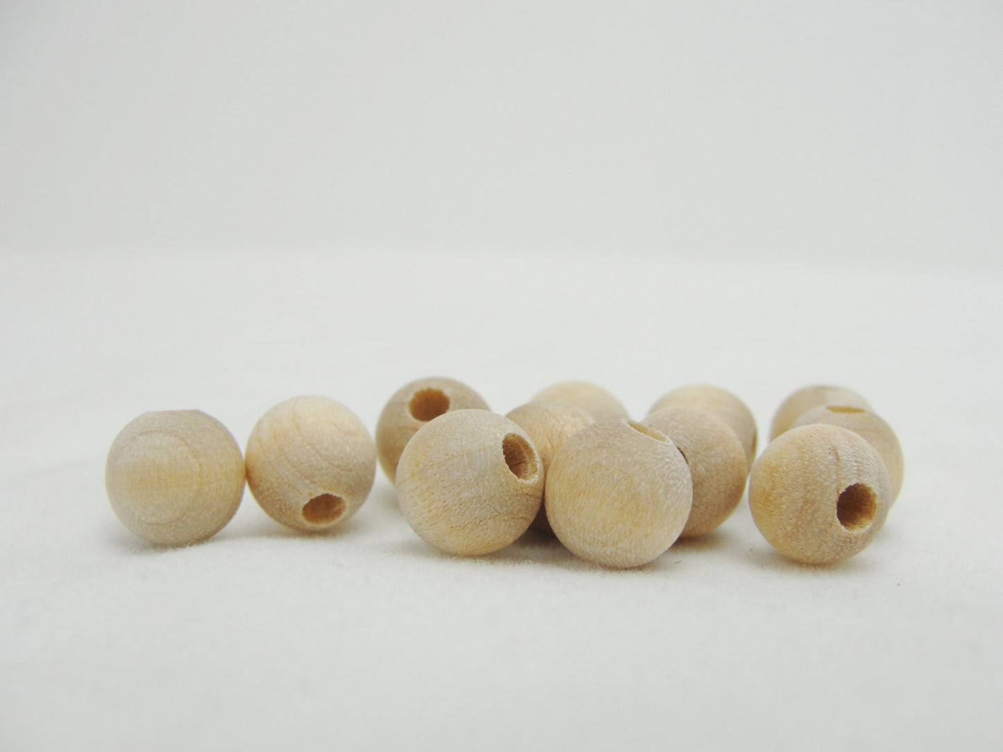 Unfinished wooden beads 8mm 1/4" (.25") with 7/64" hole - Wood parts - Craft Supply House