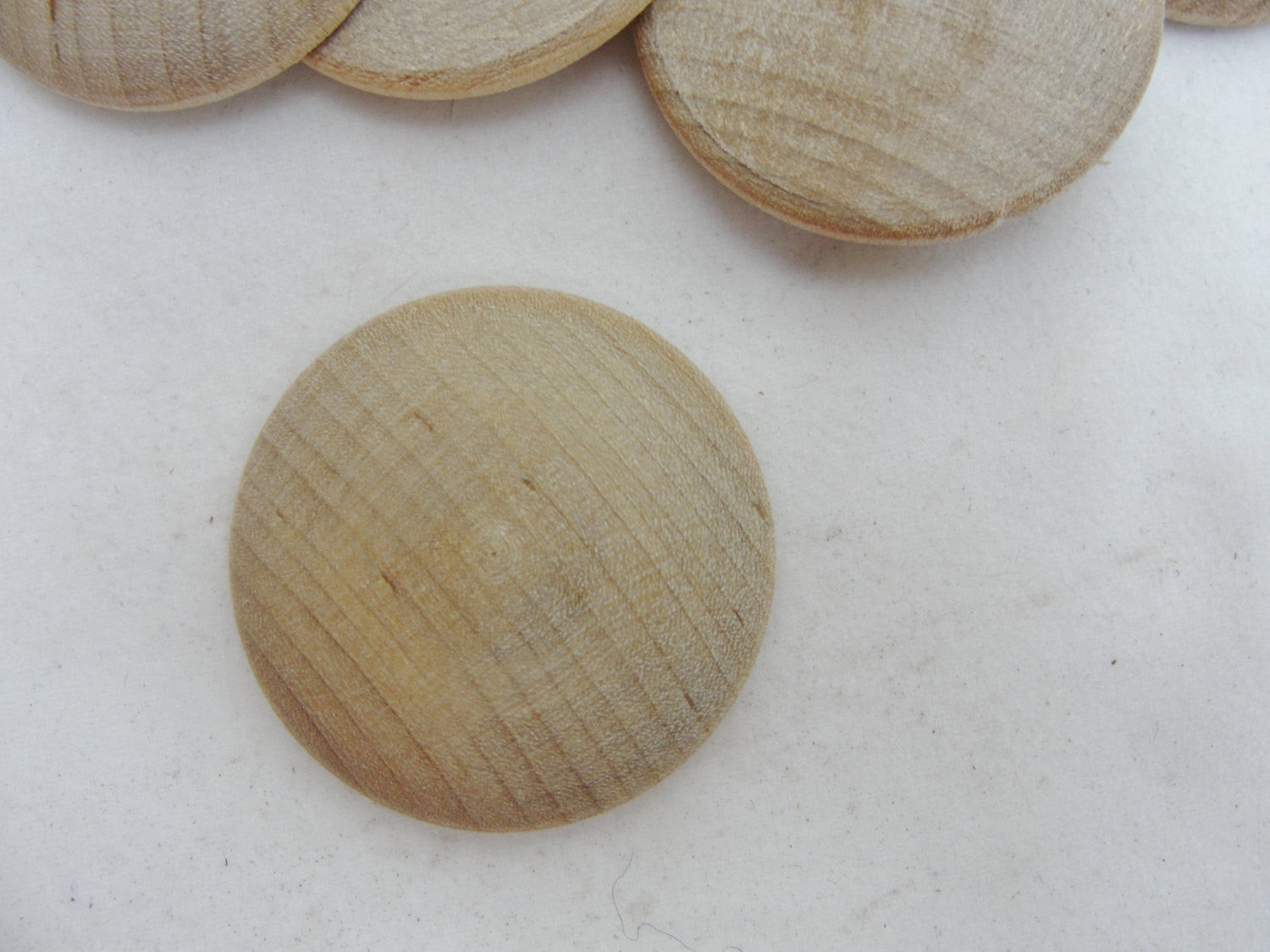 Wooden domed disc 1 1/4" wide x  5/16" thick set of 12 - Wood parts - Craft Supply House