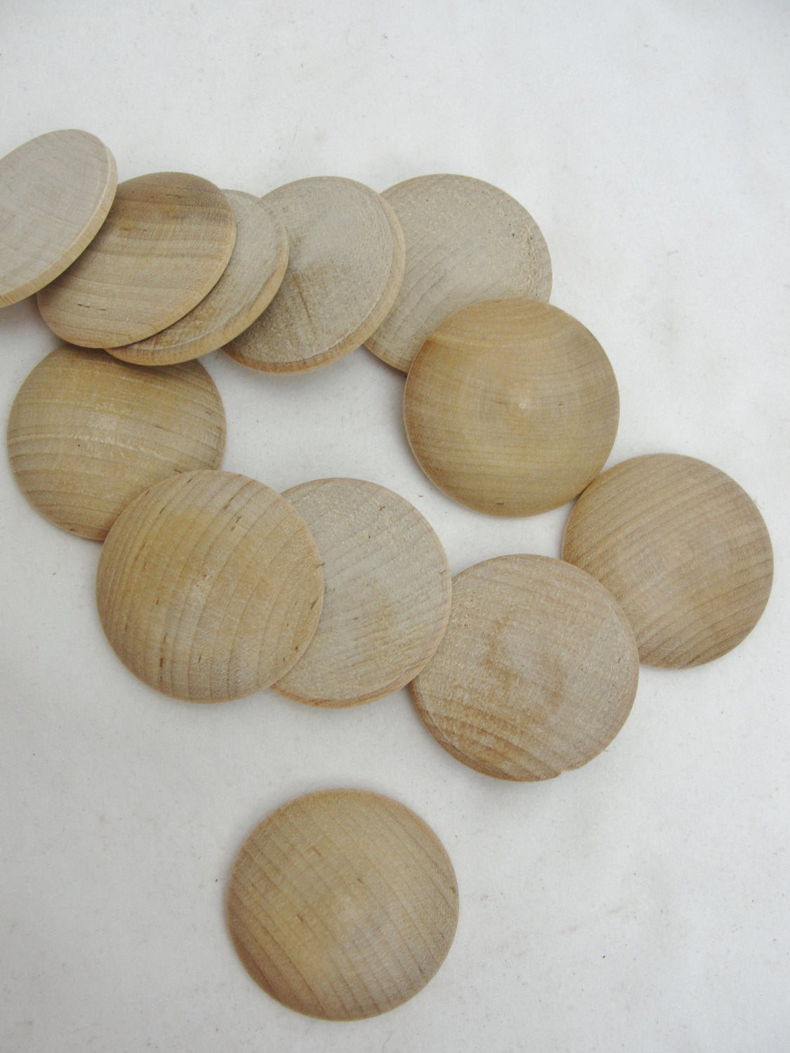 Wooden domed disc 1 1/4" wide x  5/16" thick set of 12 - Wood parts - Craft Supply House